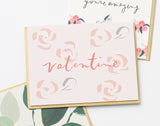 The Valentine Roses Note Card features abstract pink rose designs with “valentine” in red cursive, overlapping two floral cards; printed in Los Angeles.