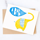 A Baby!! Greeting Card featuring a yellow elephant and a blue speech bubble that says A BABY!!!!.