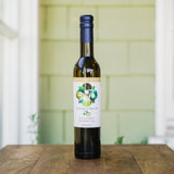 A Taste of Santa Barbara Gift Box rests on a wooden table before a pale green wall with white trim.