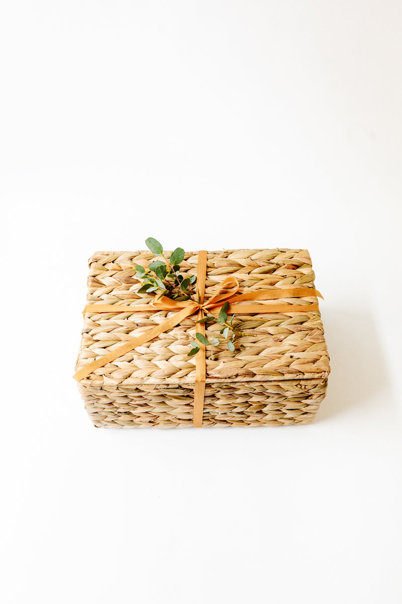 Water hyacinth basket with ribbon & eucalyptus leaves