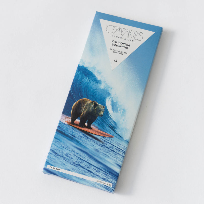 Chocolate bar packaging with a bear on a surfboard design on a white background