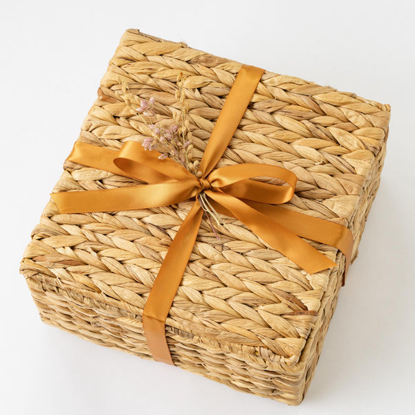 Santa Barbara Company Woven Gift Basket Tied with Ribbon