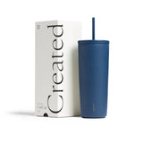A 24oz Cold Cup in Pacific Blue with a straw stands next to a white box labeled Created.