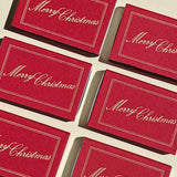 Six scarlet red Matchbox Merry Christmas boxes arranged in a grid, each featuring the words Merry Christmas in white script.