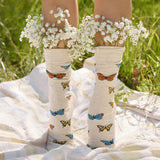 butterfly socks worn and shown with flowers