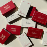 Red and white Matchbox Tis The Season party favors printed with Merry Merry, Cheers!, or Tis The Season.
