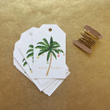 Holiday Palm Gift Tags feature a watercolor palm tree, warm wishes, and gold string. Box of 8.
