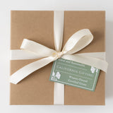 California Scene Gift Box: Brown box, cream ribbon, green tag, CA organic snacks. Women-Owned, Certified Green.