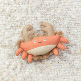 Very Crabtivating Earth Friendly Cat Toy, filled with catnip, is shown on a textured cream-colored surface.