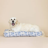 A golden retriever rests on the Indigo Vine Canvas Large Pet Bed against a plain beige background.