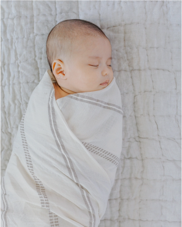 Baby wrapped in fair trade crafted swaddle