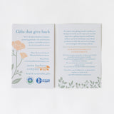 Two cards with floral designs detail the Best of Santa Barbara Gift Box’s focus on local, sustainable gifts, featuring community support practices and locally made treats like organic popcorn included in each box.