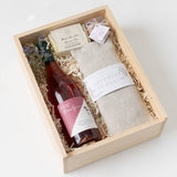 Rosé Retreat Gift Box: Includes rosé, eye pillow, soap, dried florals, chocolates—all beautifully packed.