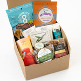 The Classic California Welcome Gift features an assortment of snacks—crackers, popcorn, caramels, almonds, tea, honey, a lollipop, and sustainable beef jerky—elegantly packed in a brown box. A perfect self-care or welcome gift.
