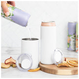 A hand pours a drink from a can into a matte white Custom Logo Shasta Thermal Tumbler 11 oz with a lid, beside another tumbler holding a can. Dried fruit slices are scattered on the white countertop and wooden board.