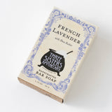 A French Lavender Soap Bar by Three Sisters Apothecary, featuring an artisan formula with Shea Butter, vintage-style design with a cauldron graphic, and purple floral borders.