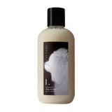 White bottle of Lavande Lavender Dog Shampoo with black cap, labeled with an illustration of a fluffy white dog"