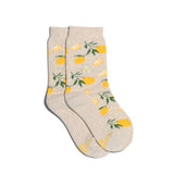 Light beige Kids Socks that Plant Trees - Lemons with yellow lemons and green leaves, laid flat on a white background.