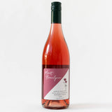 A bottle of Indulgent Rosé Gift Box—pink label, black cap, white background—ideal for a wooden gift box.