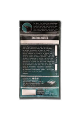 Back of a teal Artisanal Chocolate Bar 1.4oz with tasting notes, serving tips, and company info in white text.