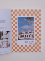 The Ojai Guidebook from Jaunt Journals showcases Hotel El Roblar on a bold orange-and-white checkerboard page.