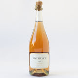 A Riverbench Wine & Chocolate Gift Box featuring a bottle of Brut Rosé sparkling wine with a cork top, white label, and gold foil accents, photographed against a plain white background.