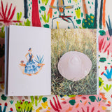 The Santa Barbara Guide Book features an illustration of a woman in blue and a white hat on grass.