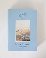 The Santa Barbara Guide Book from Jaunt Journals has a blue cover with a beach photo and striped umbrellas.