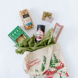 Gift with a Seasons Greetings holiday bag, chocolate, and other items on a white background