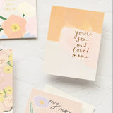 The Seen & Loved Mama Note Card is a floral-themed Mother’s Day card with gold foil and the message "you’re seen and loved, mama.