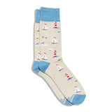 Socks that Protect Oceans in oatmeal with light blue cuffs, heels, and toes, featuring sailboats, red and white lighthouses, and seabirds