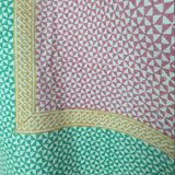 Sunrise Fair Trade Block Printed Linen, handcrafted in India with green, pink, yellow hues and white triangles.
