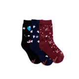 Three pairs of kids space socks: black with planets, navy with rockets, and burgundy with constellations