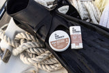 Tinted Sunscreen Stick SPF 30 rests on black fins, with a coiled white rope in the background.