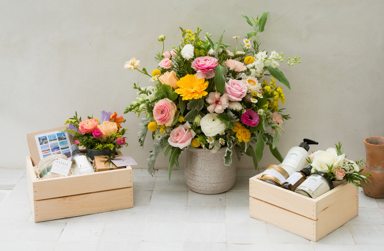 colorful flowers and gift baskets on a counter