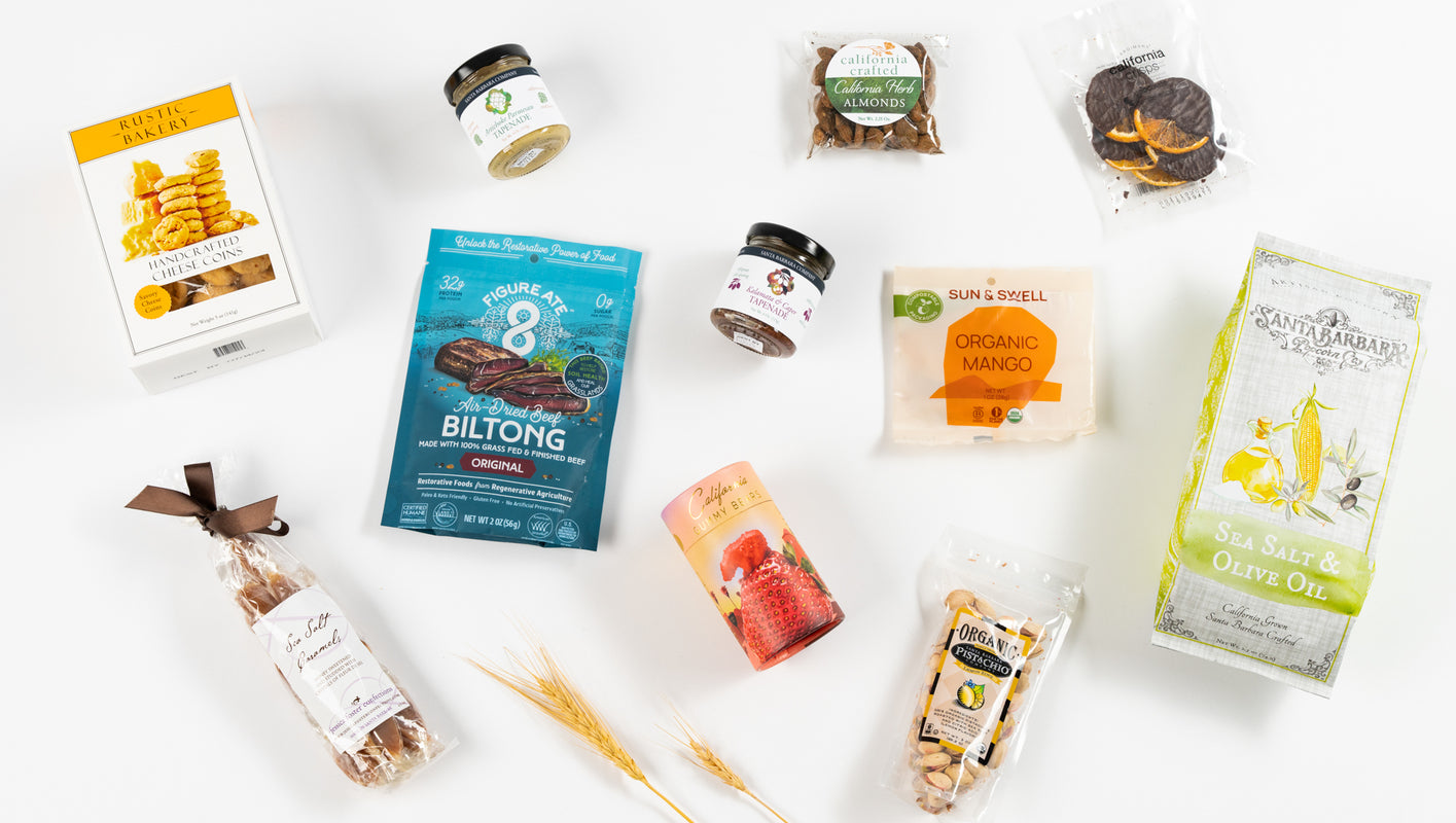 Array of California Snacks on white background including dried fruit, popcorn, jerky, cracker, caramels and more.