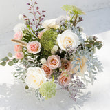 The Full: A seasonal mix of blush & white roses, greenery, and fillers in a white vase.