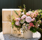 pink floral arrangement with gift box