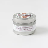 Pomegranate Travel Candle, 3oz soy wax in floral-lid silver tin, shown on white background.