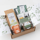Savor Snack Box: artisan popcorn, organic mango, almonds, tea bags & mint chocolate in decorative packaging.