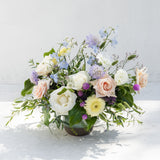 The Full: A seasonal mix of pastel roses and local blooms, artfully arranged in a round vase.