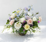 Champagne + Flowers: Sustainably grown white, peach & purple blooms with greenery, artfully arranged in a round vase.