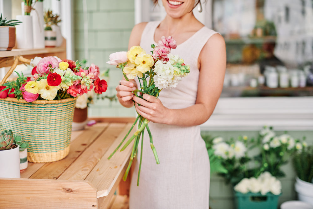 florist putting together a bouquet with spring flowers