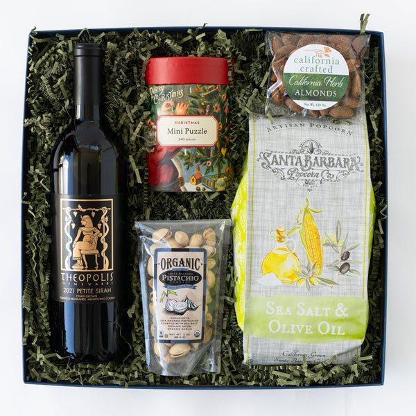 Gift box with wine, snacks, and a puzzle on a white background