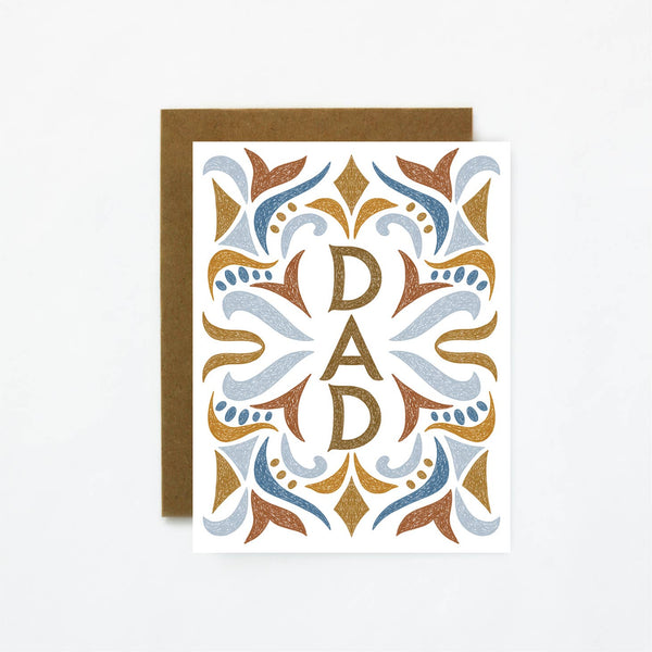 A card featuring the word dad surrounded by a festive pattern in light blue, brown and dark blue.