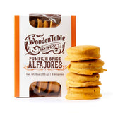 Box of Pumpkin Spice Alfajores Cookies with dulce de leche, stacked against a white background.