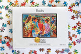 The Buds Farmers Market Puzzle is a 1000-piece box featuring colorful watercolor art of people with flowers at a farmer's market. The box, shown with scattered pieces, highlights that a full-size poster is included.