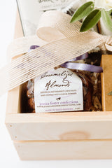The Chocolate Gift Box features a jar of caramelized almonds dipped in bittersweet chocolate, elegantly wrapped with purple and cream ribbons. The label reads Jessica Foster Confections, making this a perfect gift.