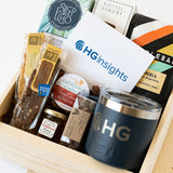 The HG Insights Customer Welcome Gift includes a branded Yeti mug, assorted snacks, honey, a California Crafter snack pack, and an HG Insights card, all presented in a branded HG Insights Wood Box.