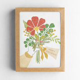 The Happy Holidays Bouquet Card Boxed Set comes in a brown box and features an illustration of a hand holding a bouquet of red, yellow, and green flowers with a "Happy Holidays" tag.